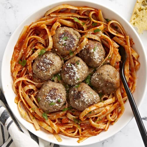 Overhead view of a bowl full of spaghetti with turkey meatballs on top.