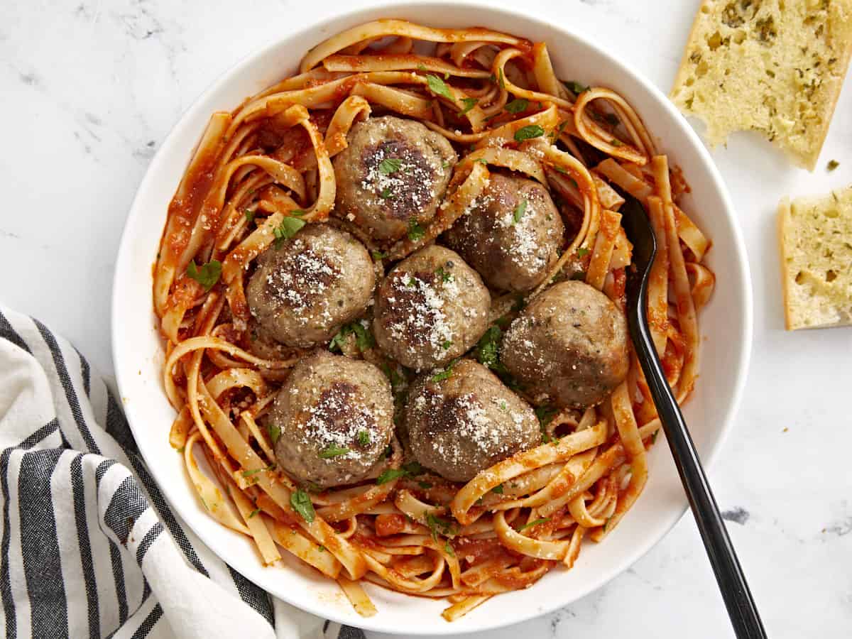 Overhead view of a bowl full of spaghetti with turkey meatballs on top.