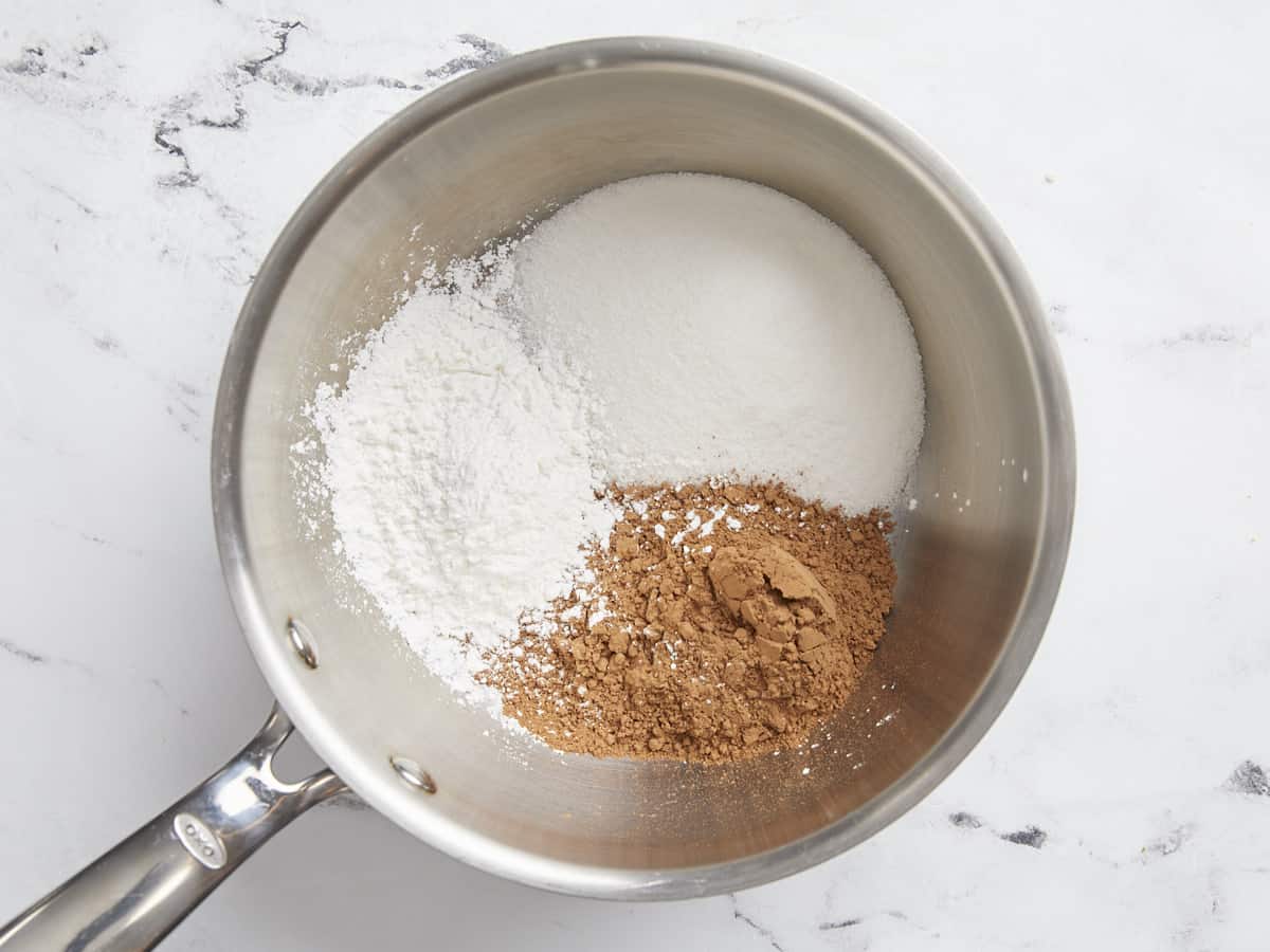 Sugar, cocoa powder, and cornstarch in a sauce pot.