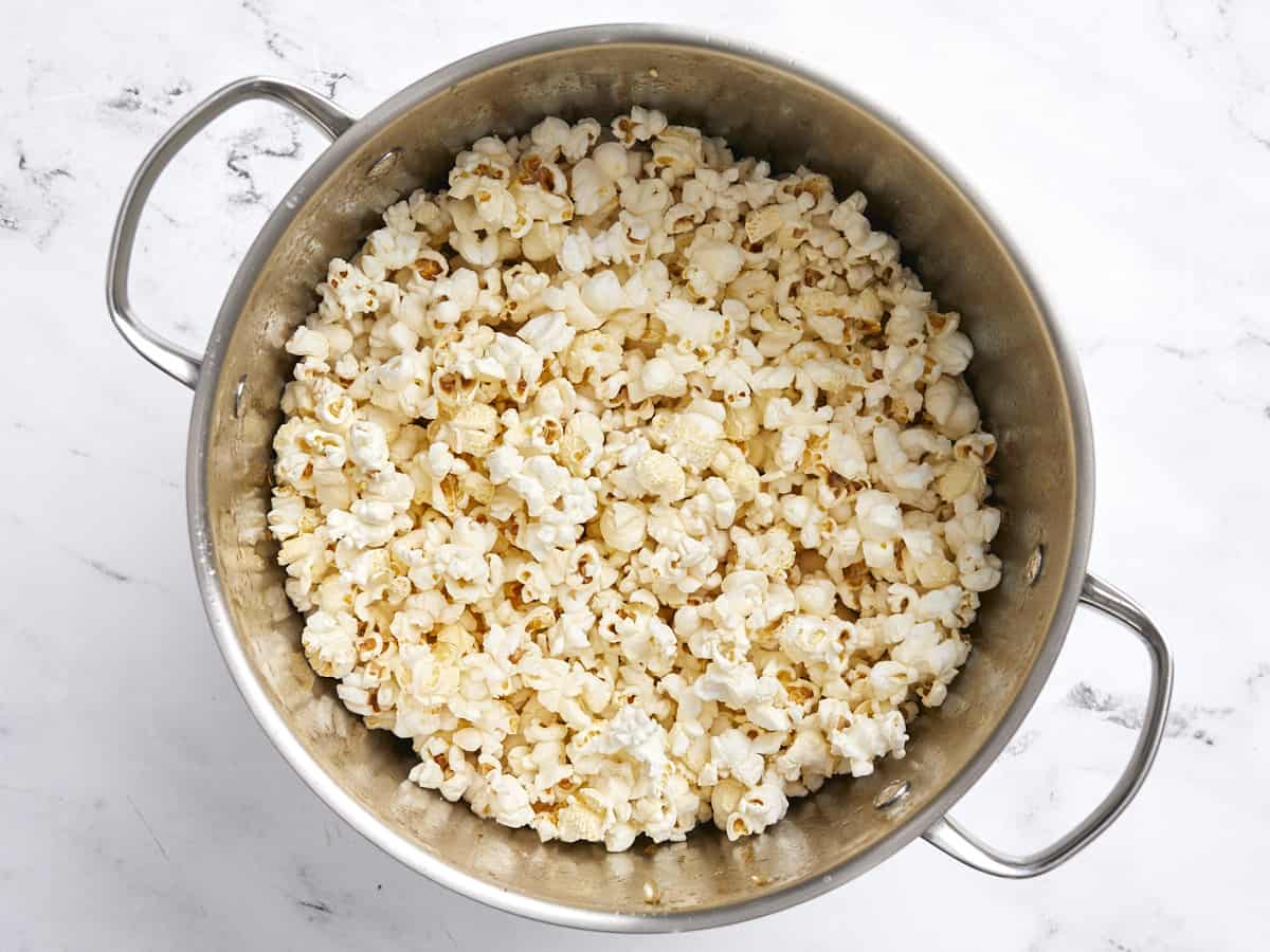 Overhead view of a large pot full of popped popcorn.