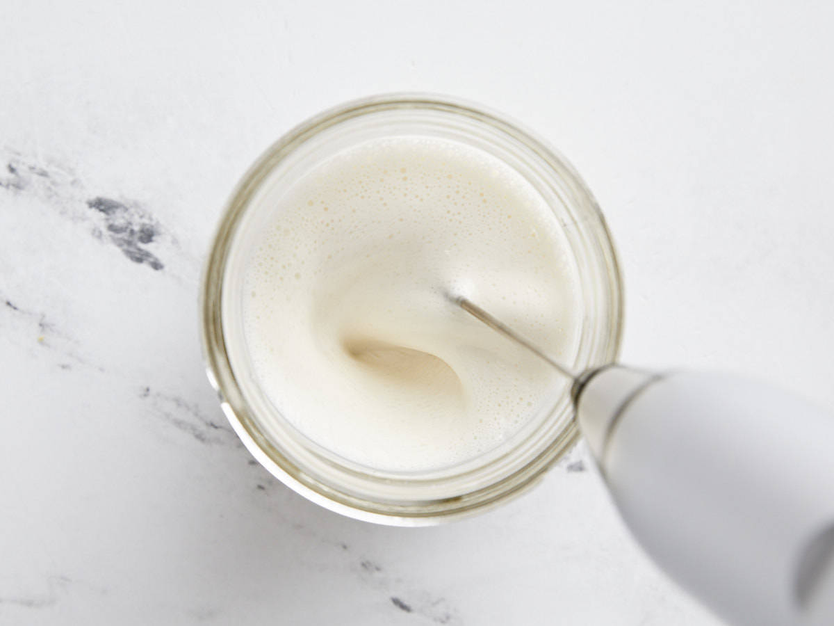 Sweet cream cold foam being whisked in a jar. 