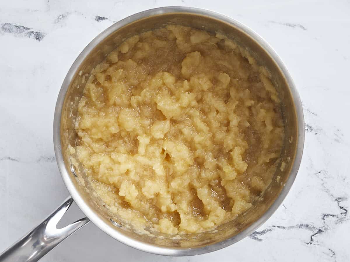 Overhead view of mashed homemade applesauce in a small saucepan.