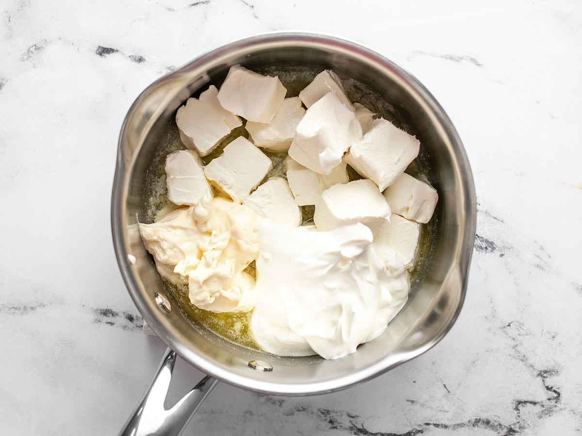 Cream cheese, sour cream, and mayonnaise added to the sauce pot. 