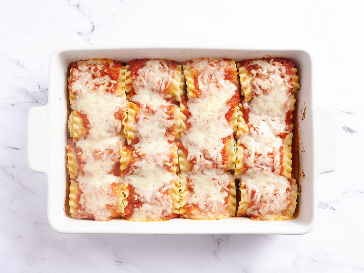 Vegetarian lasagna roll ups in a baking dish after baking.