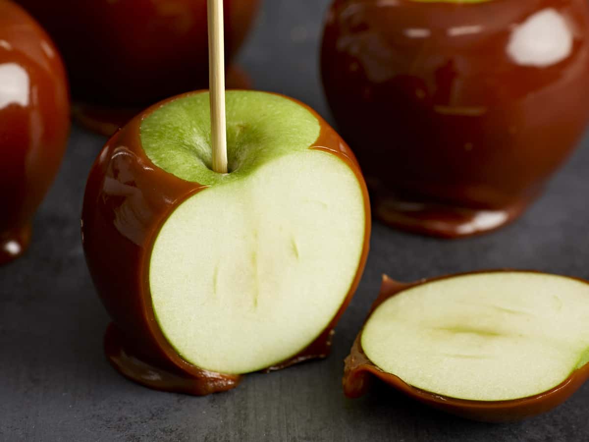 Close up of a caramel apple sliced open. 