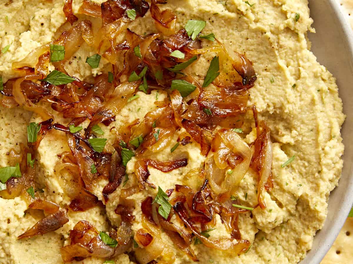 Close up overhead view of the caramelized onions on top of the chickpea dip.