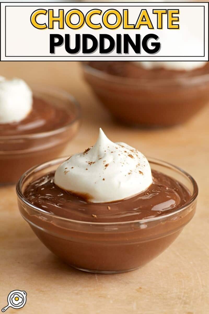 Chocolate pudding in small cups topped with whipped cream.