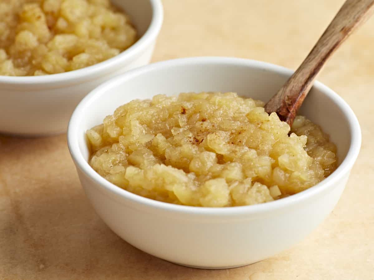 Side view of two bowls of homemade applesauce.