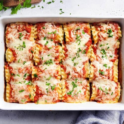 Overhead view of lasagna roll ups in a baking dish.