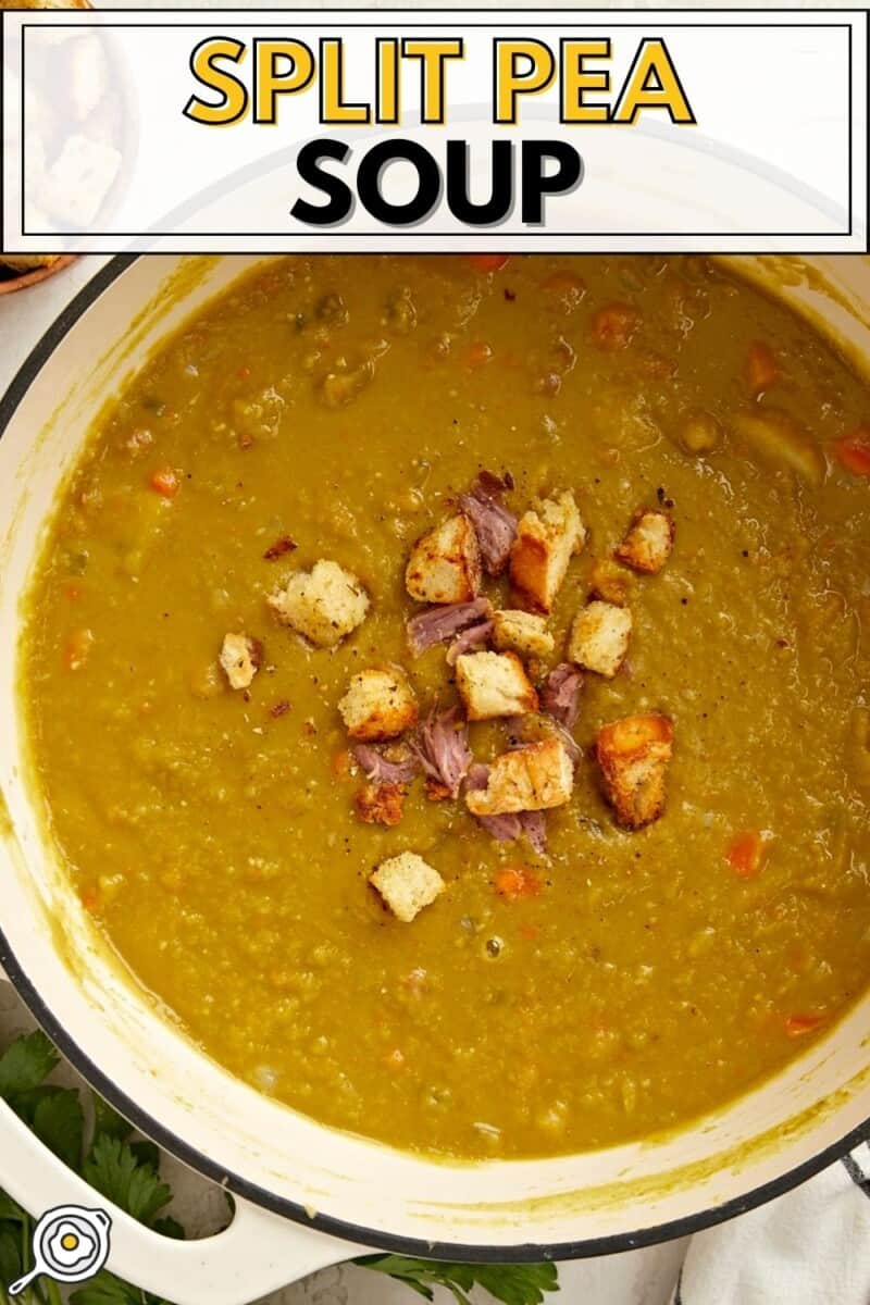 Overhead view of a pot full of split pea soup with homemade croutons on top.