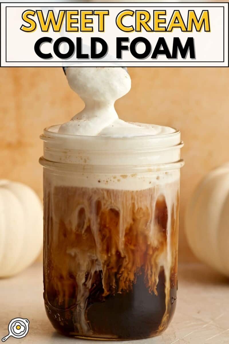 Sweet cream cold foam on a mason jar full of iced coffee.