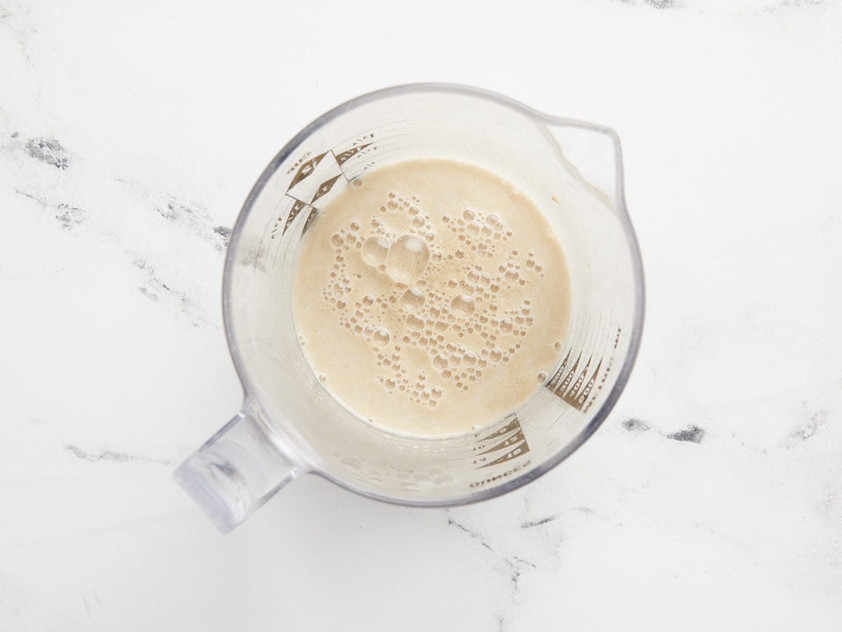 Frothy yeast in a liquid measuring cup.