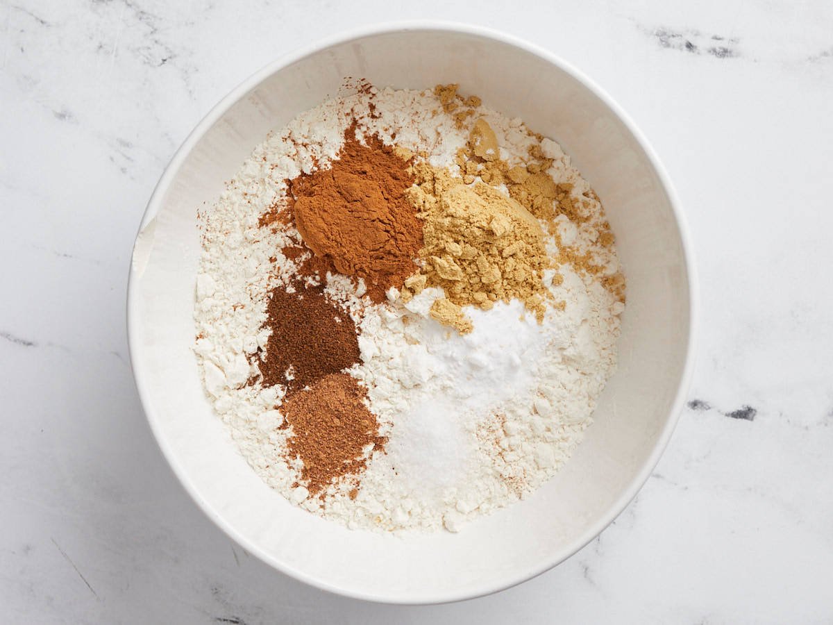Dry ingredients for gingerbread cookies in a mixing bowl. 
