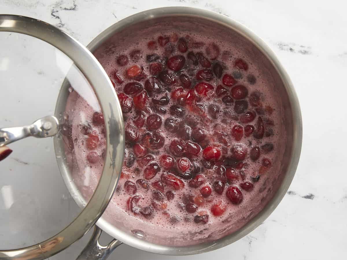 Half boiled cranberries in the pot. 