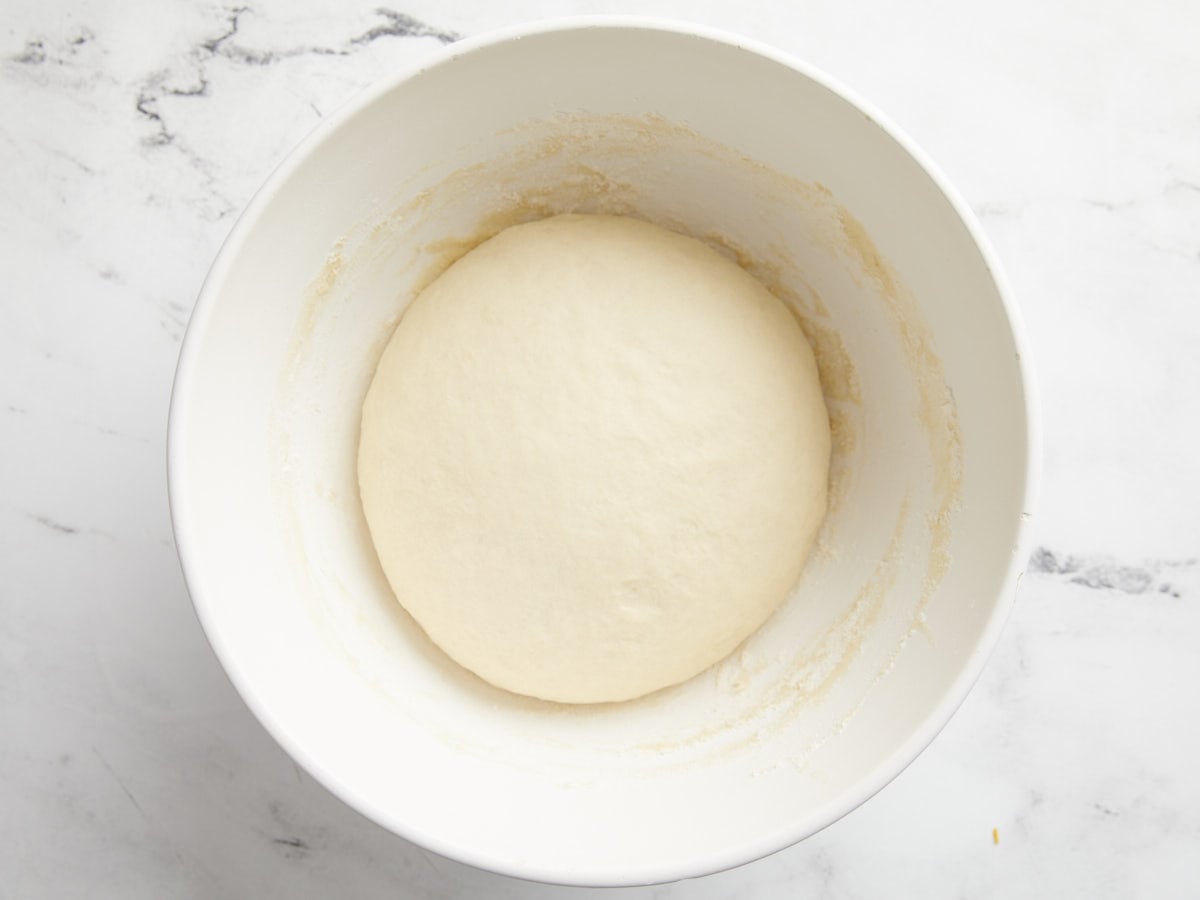 risen ball of dough in the bowl.