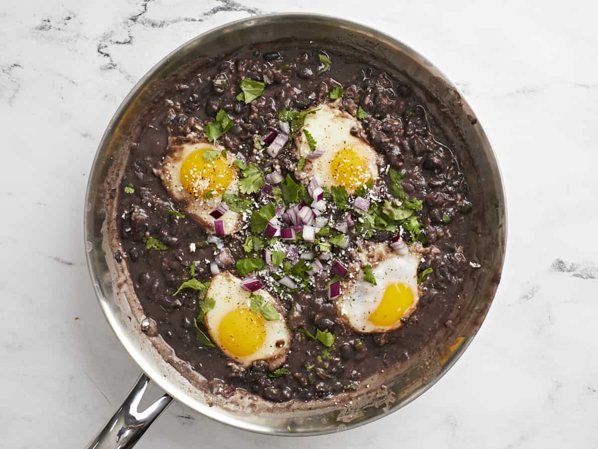 Eggs and beans topped with cilantro and onion. 