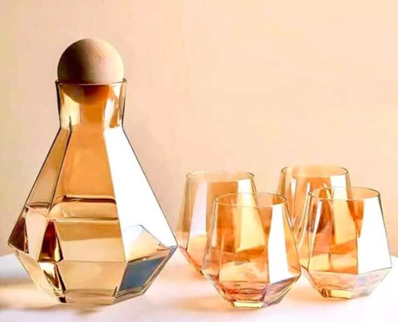 Metallic glass decanter set with four glasses. 
