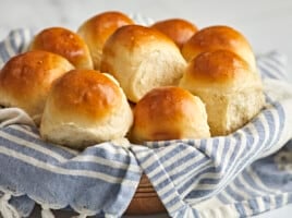 Side view of dinner rolls in a basket.