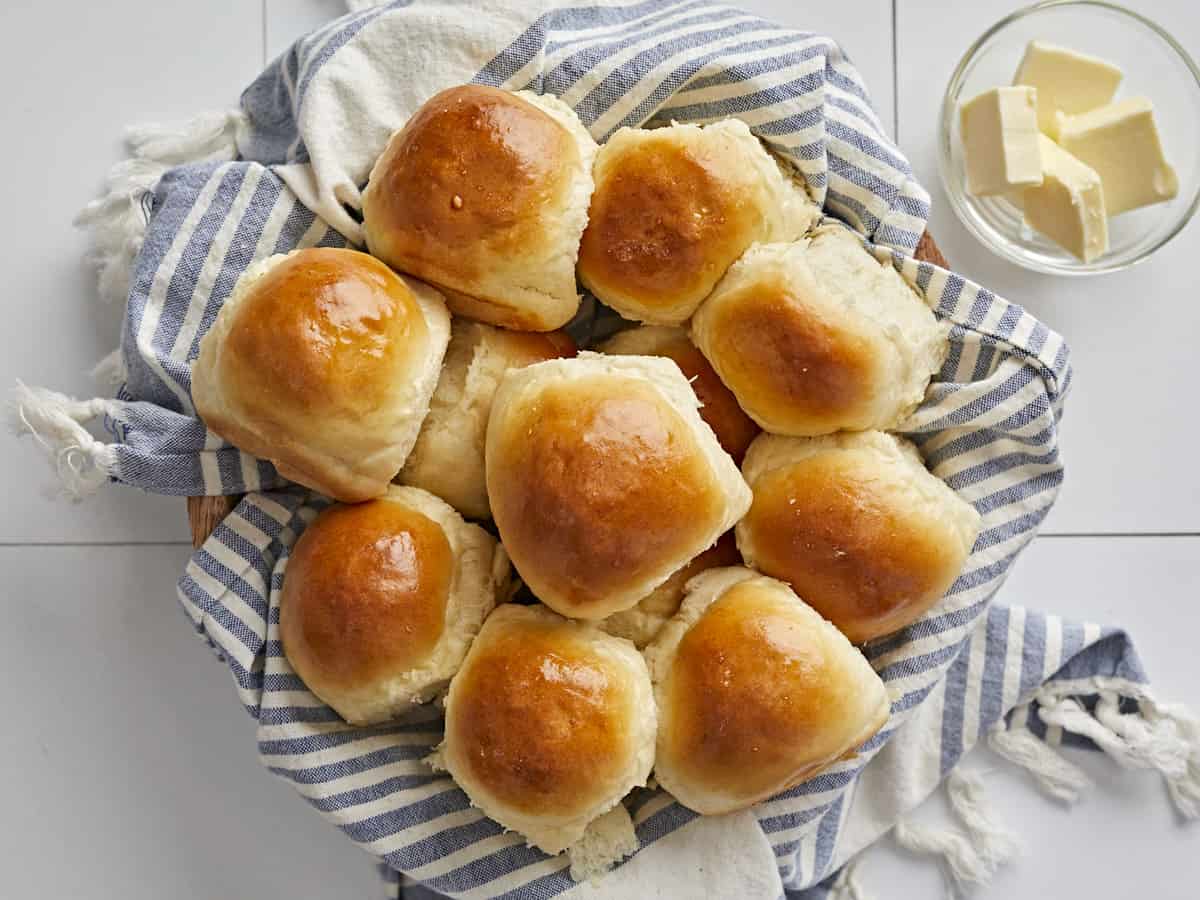 Overhead view of a basket full of dinner rolls.