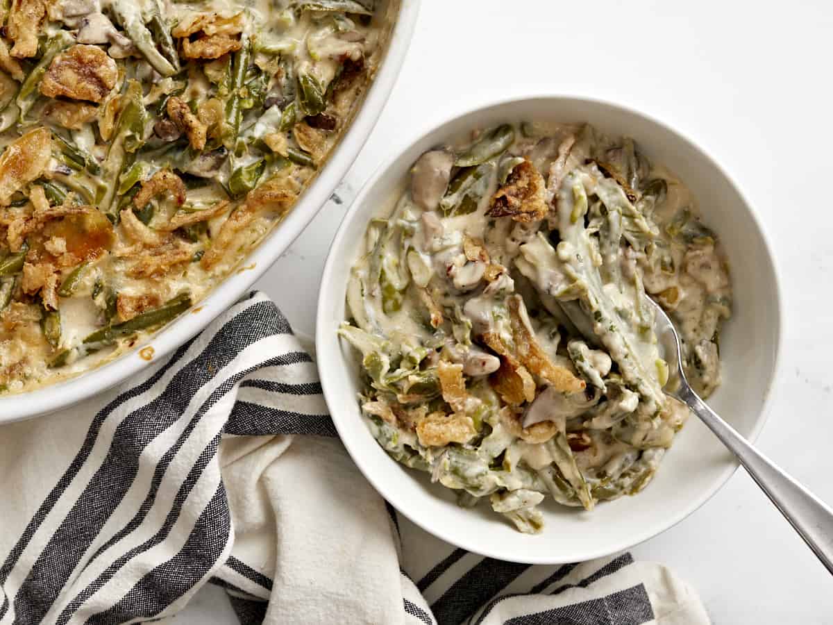 Green bean casserole dished out into a bowl with a fork.