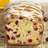 Front view of a sliced loaf of orange cranberry bread.
