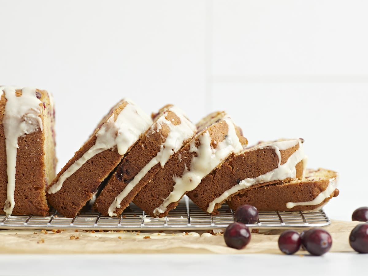 Side view of slices of cranberry orange bread fallen like dominos. 
