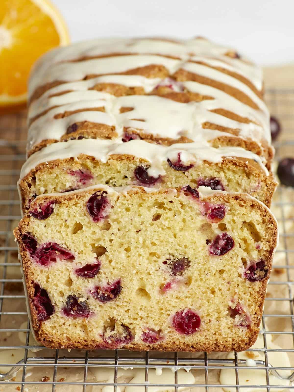 Front view of a sliced loaf of cranberry orange bread.