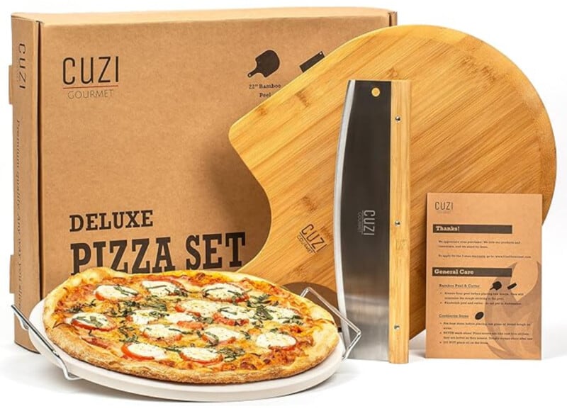 Product image for a homemade pizza set including paddle, stone, cutter, and booklet. 