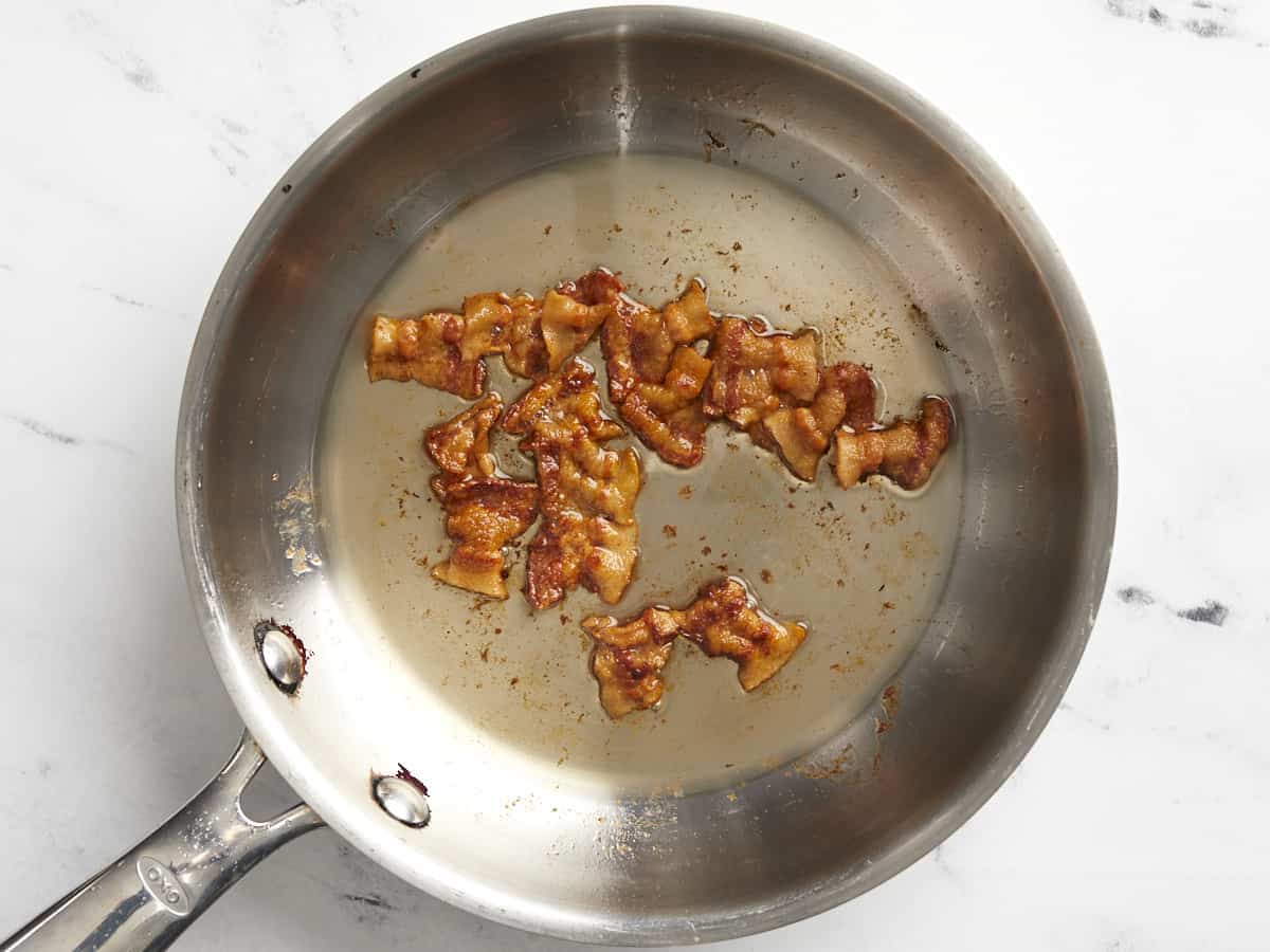 Cooked bacon in a skillet. 