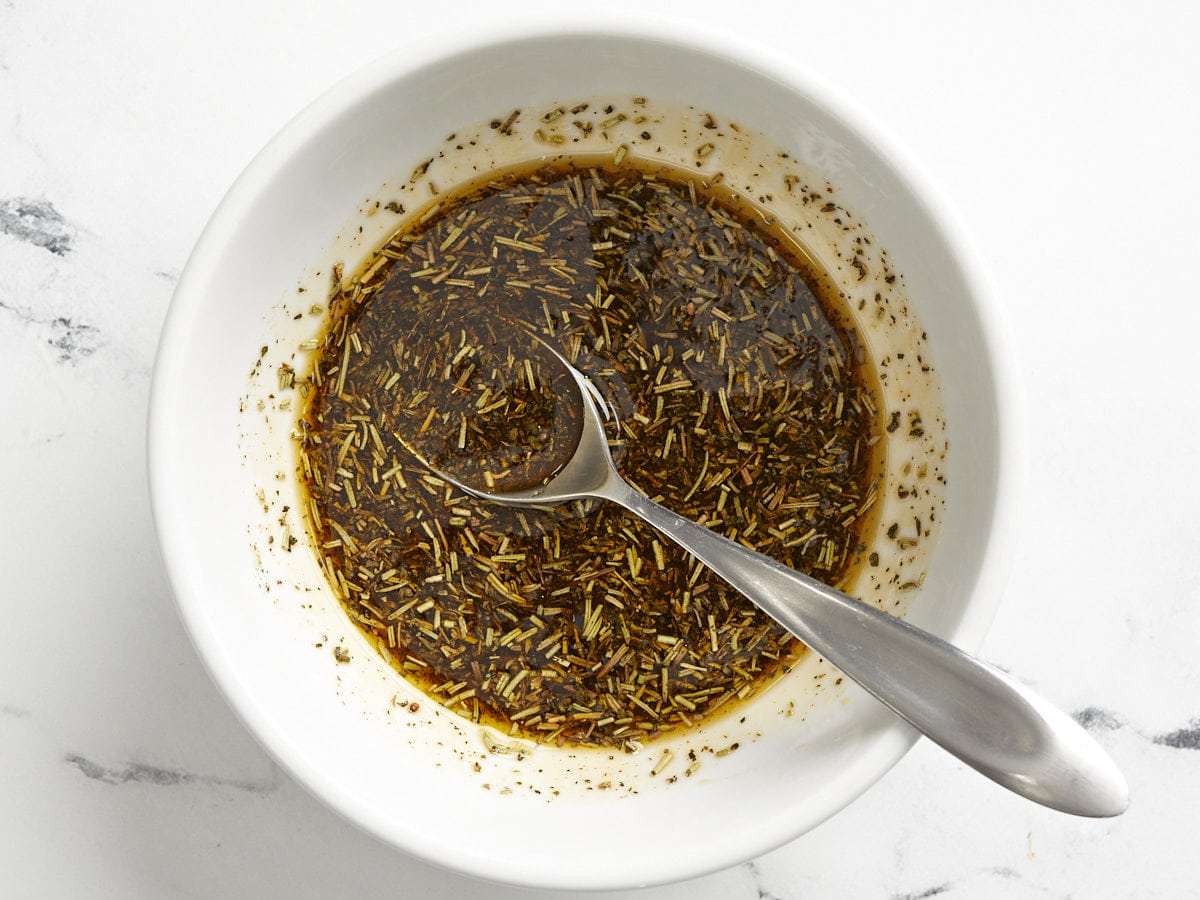 Herb seasoning mix in a bowl with oil. 