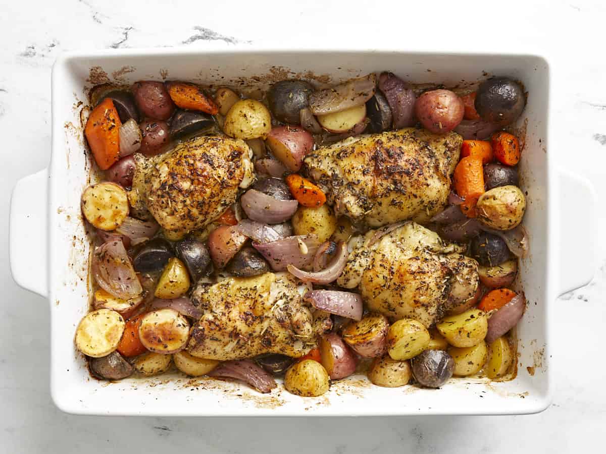 Roasted chicken and vegetables in the casserole dish. 