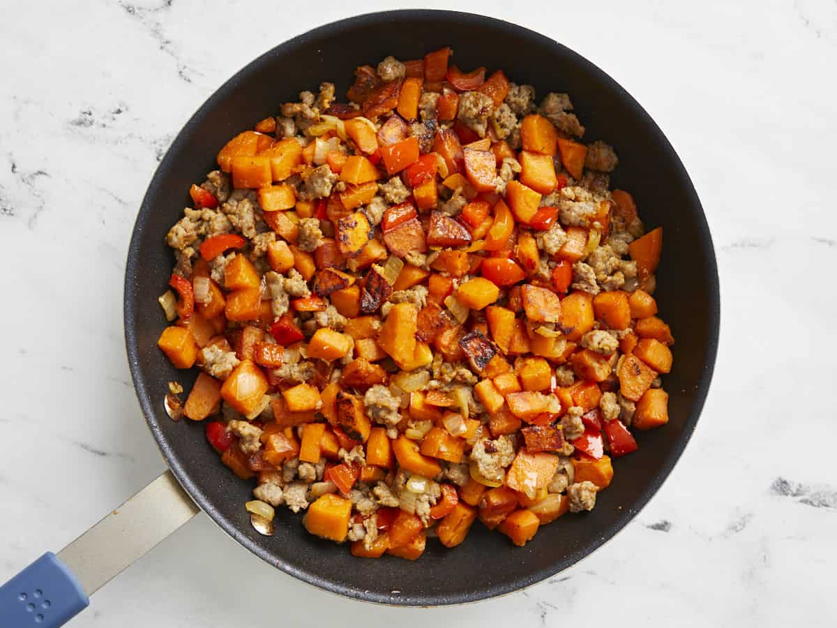Finished sweet potato hash in a skillet.