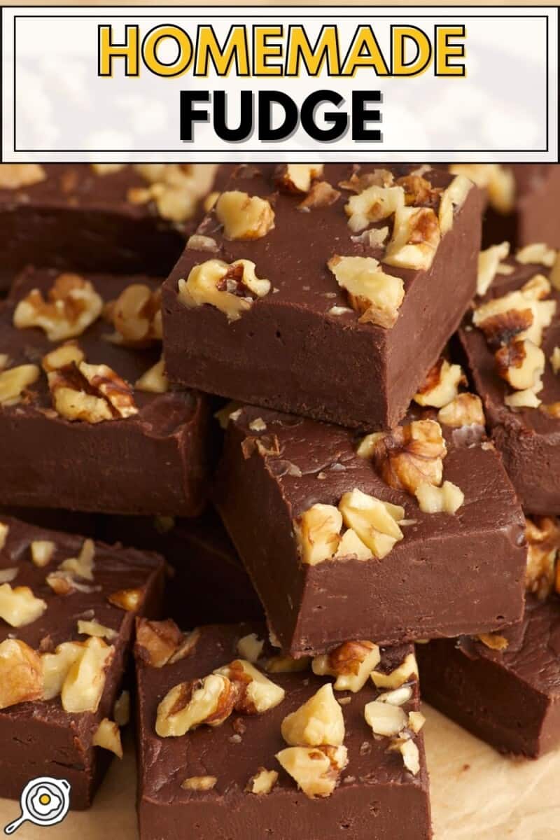 Stacked squares of homemade fudge with walnuts.