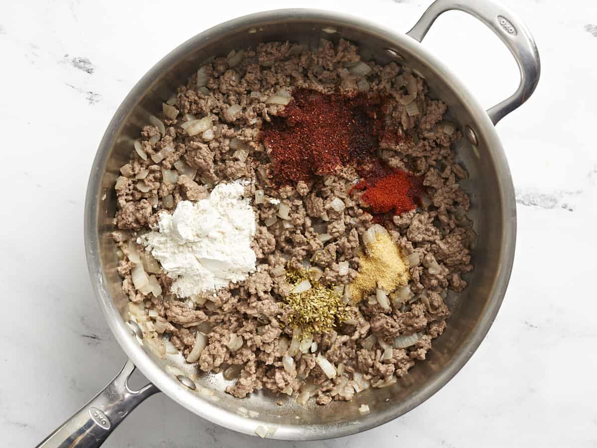 Flour and spices added to browned ground beef in the skillet. 