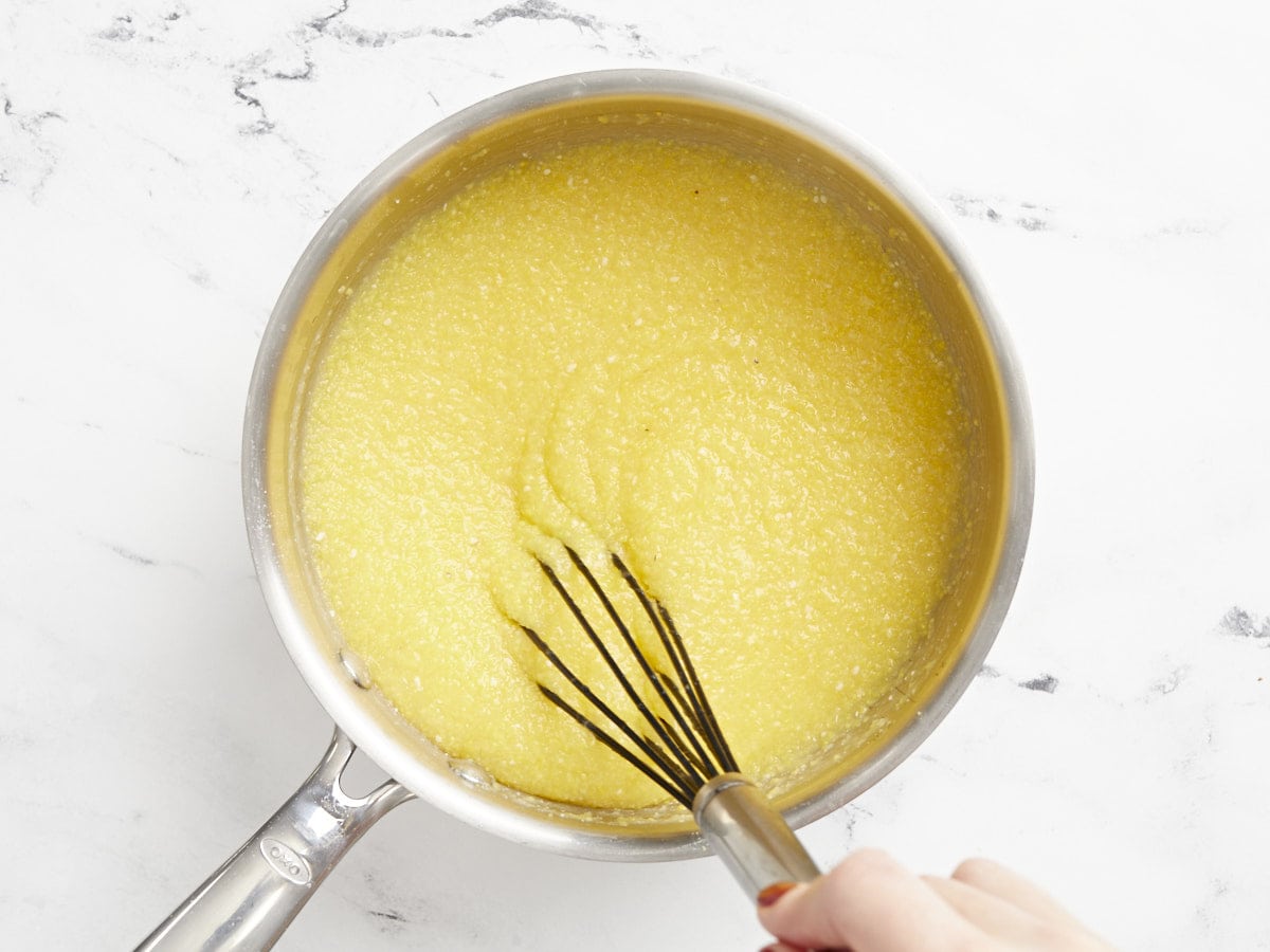 Polenta being whisked into the broth.
