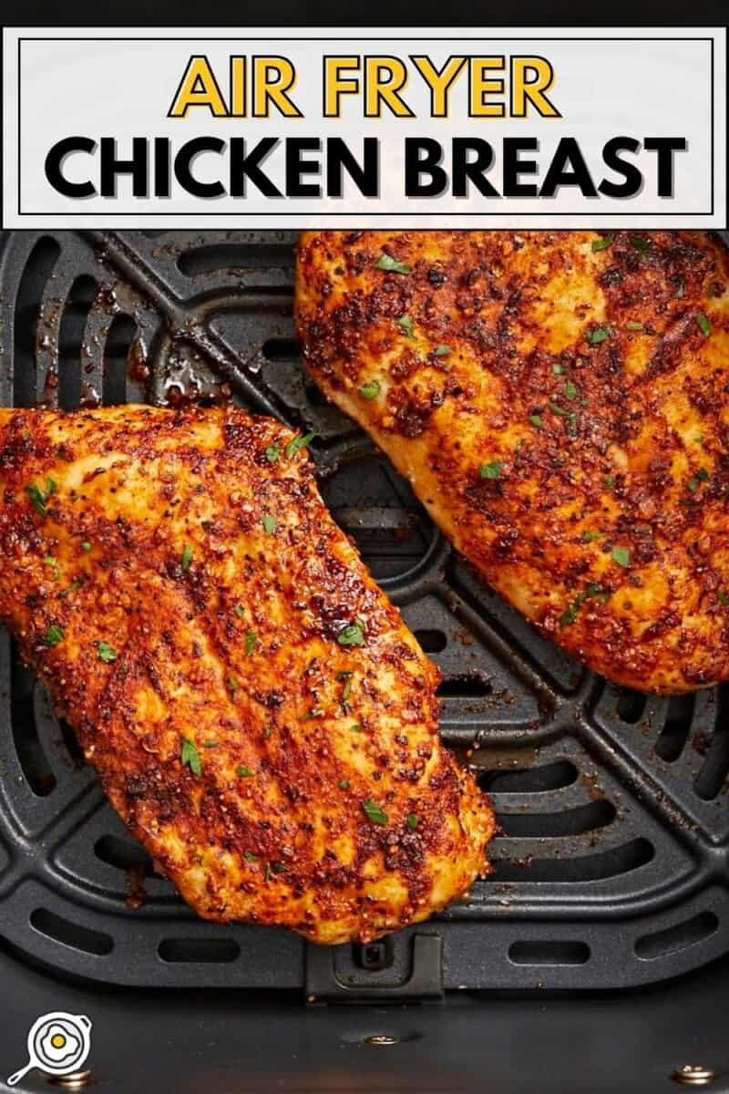 Cooked overhead view of Air Fryer Chicken Breasts in an air fryer basket with title text at the top.