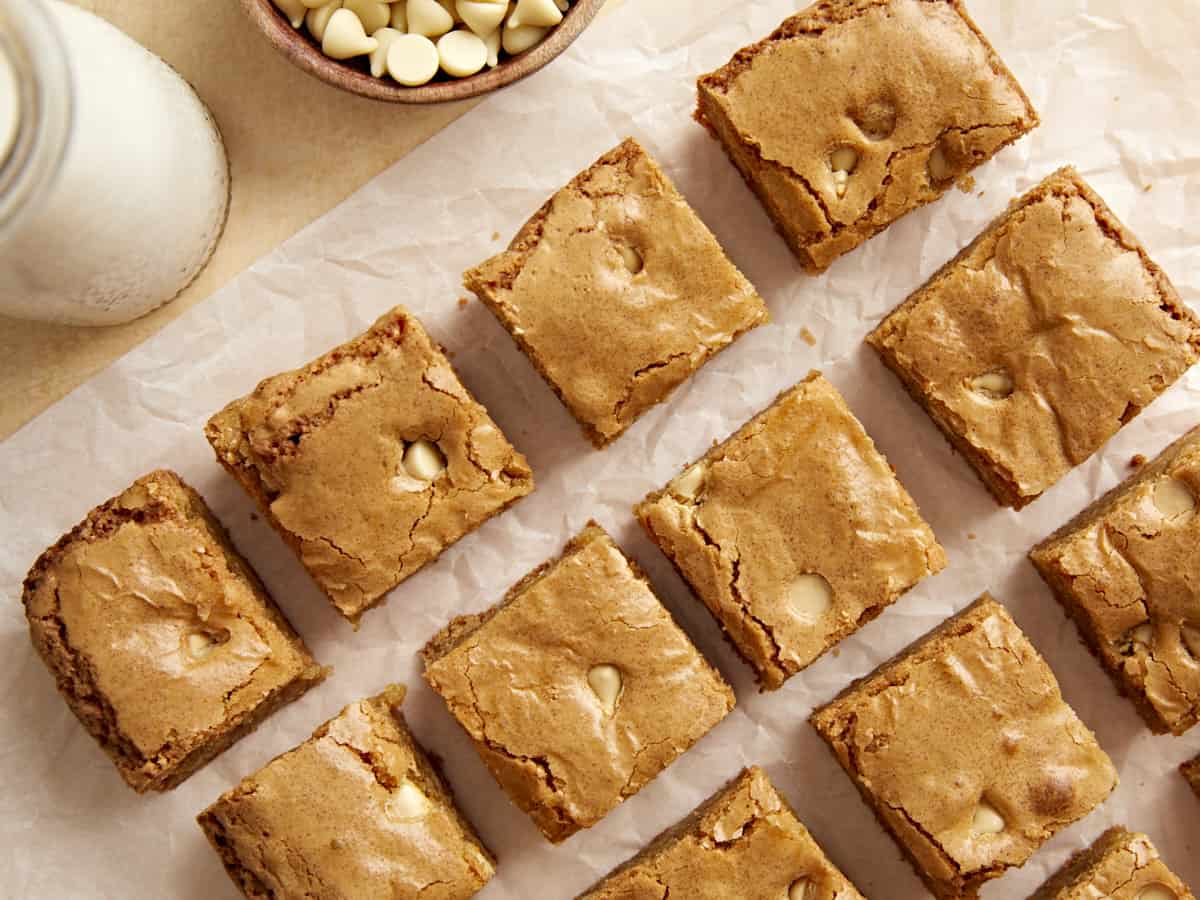 Overhead photo of blondies on a parchment lined baking sheet.