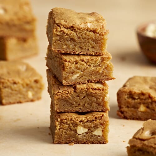 Side close up view of four blondie bars stacked on top of each other.