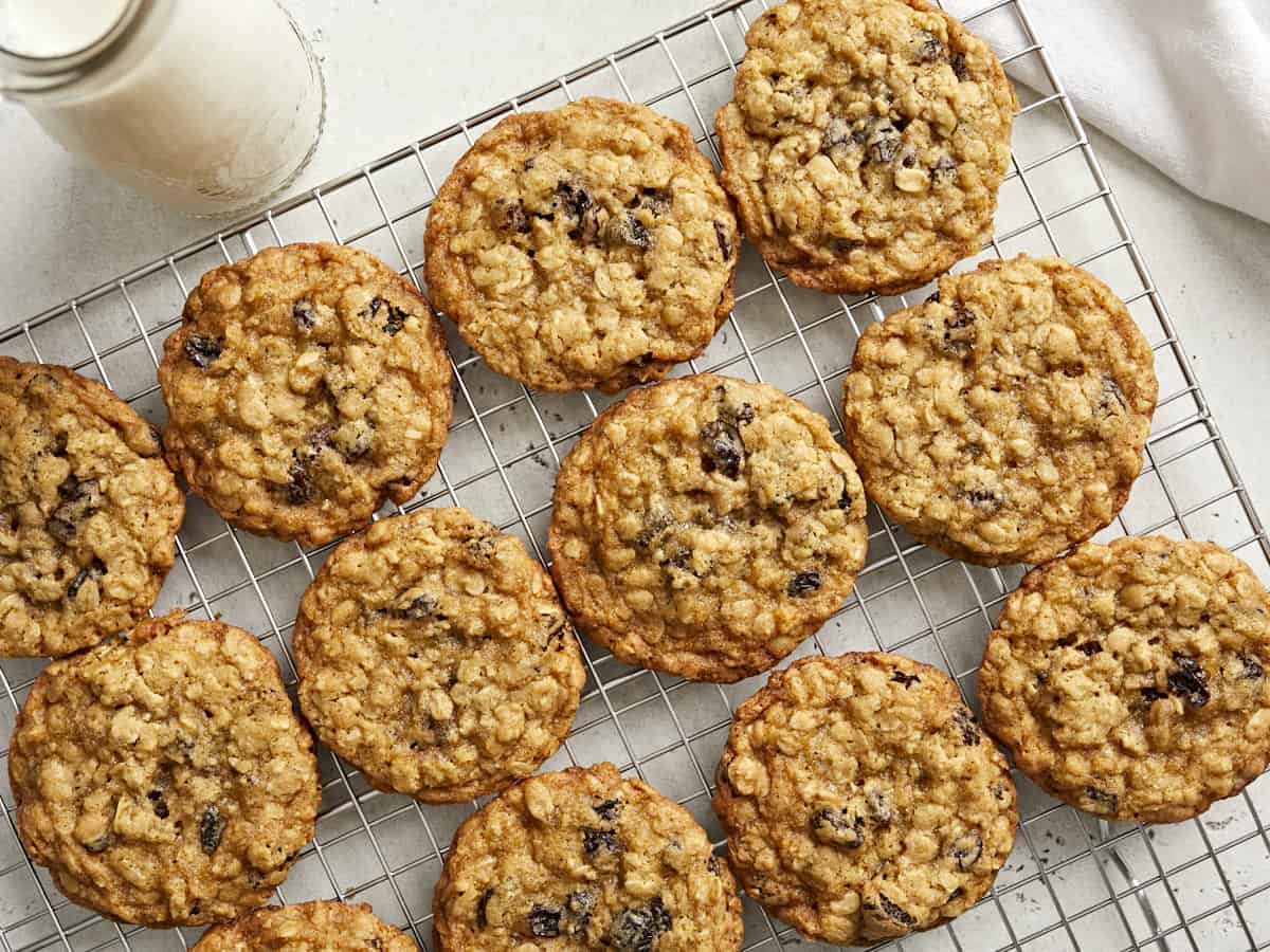 Overhead view of oatmeal raisin cookies on a cooling rack.