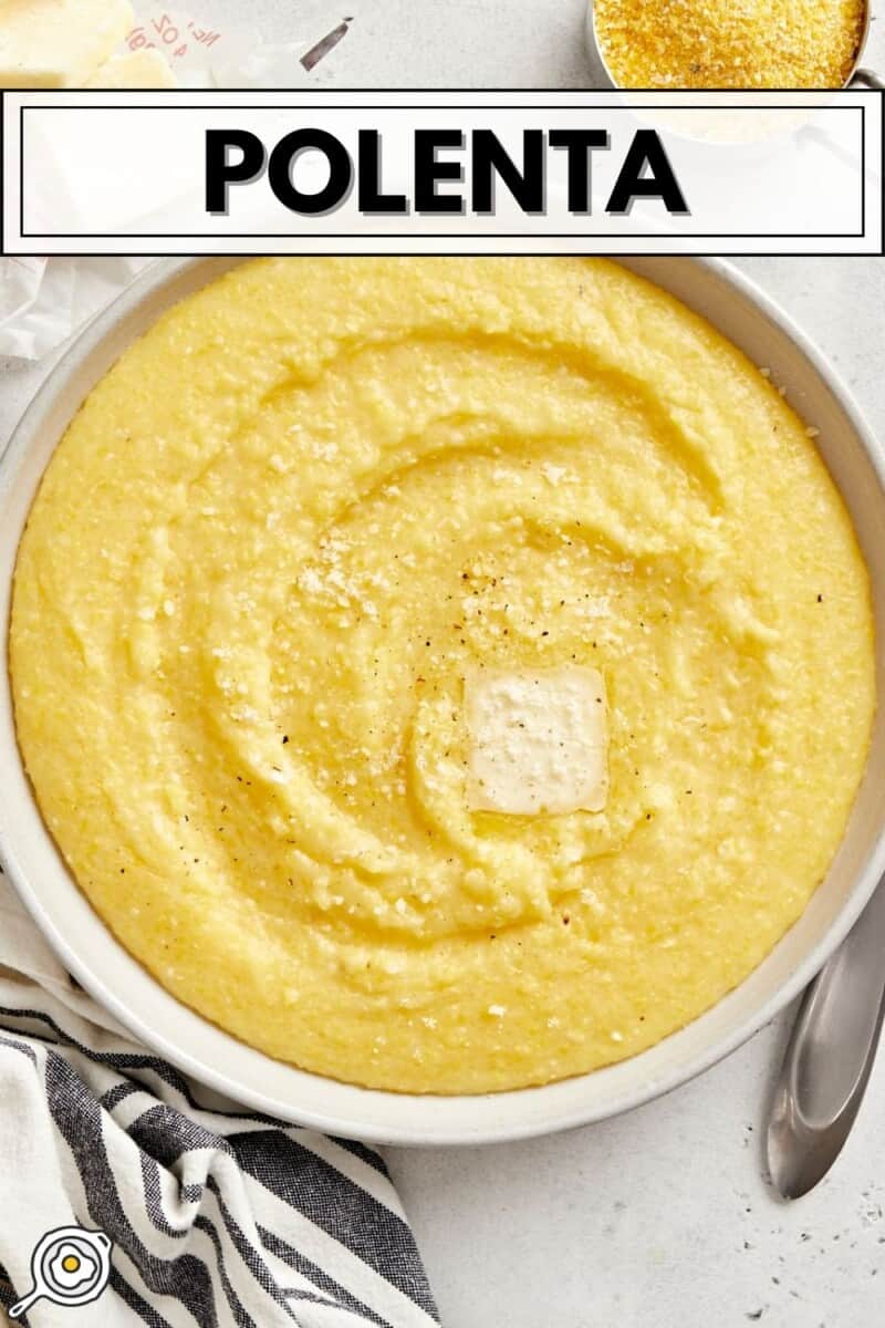 Overhead view of a bowl full of polenta with a pat of butter on top.