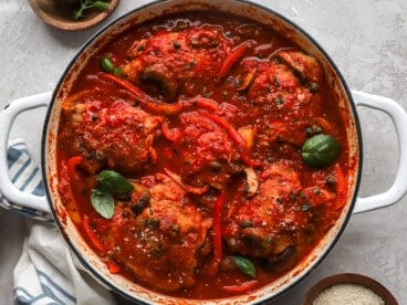 overhead view of chicken cacciatore in a white pan.