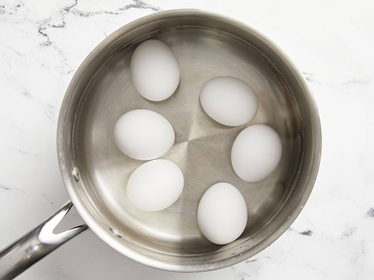 Six eggs in a pot of boiling water
