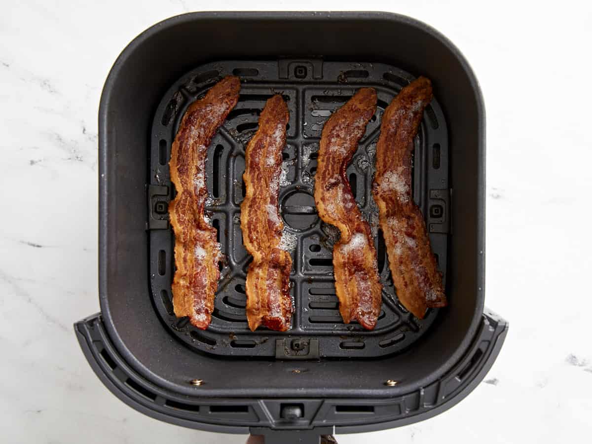 Cooked bacon strips in an Air Fryer Basket
