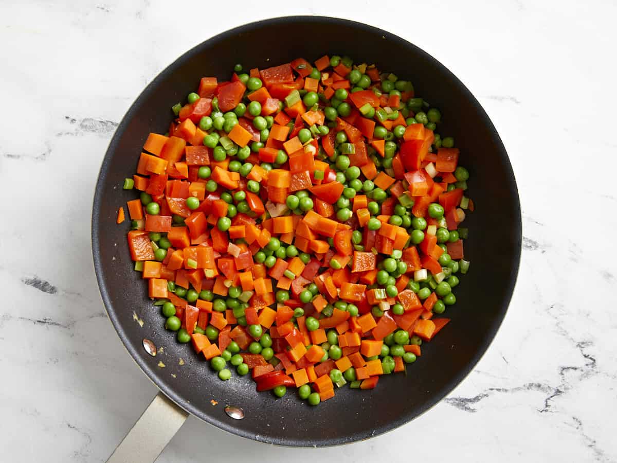 diced vegetables in a frying pan.