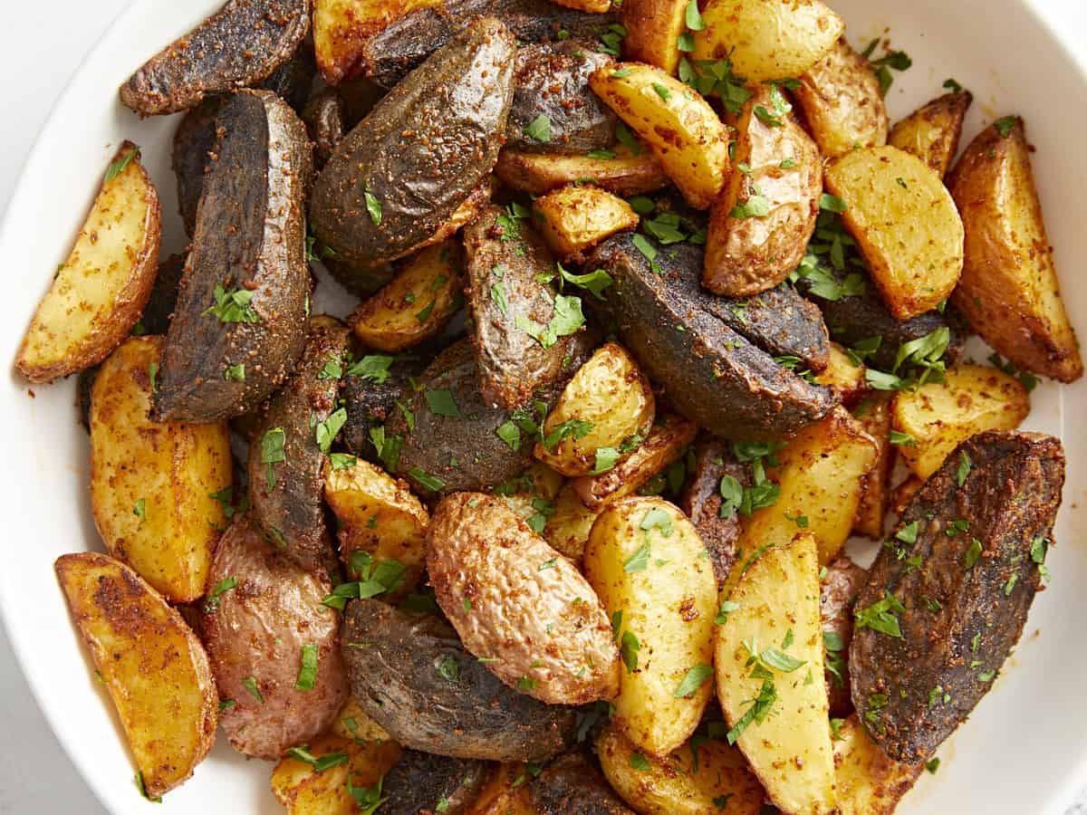 seasoned potatoes in a bowl with herbs.