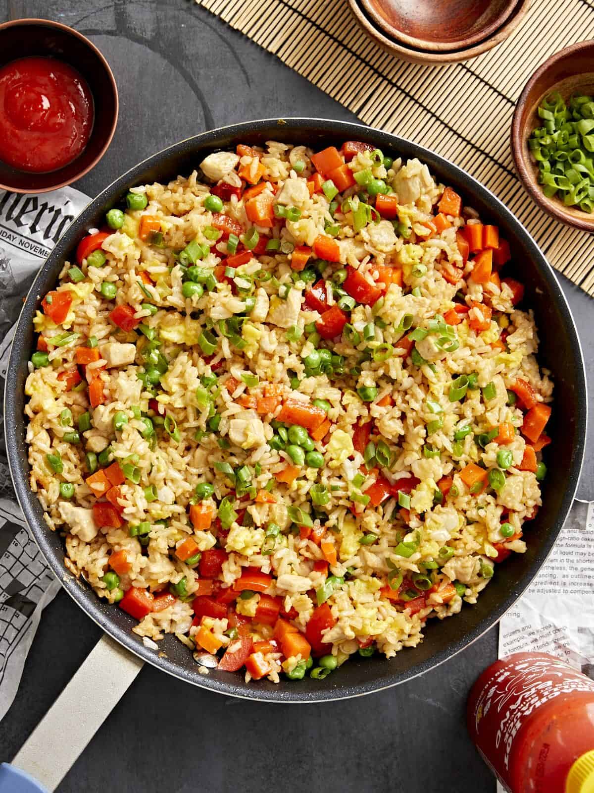 overhead view of chicken fried rice in a frying pan.