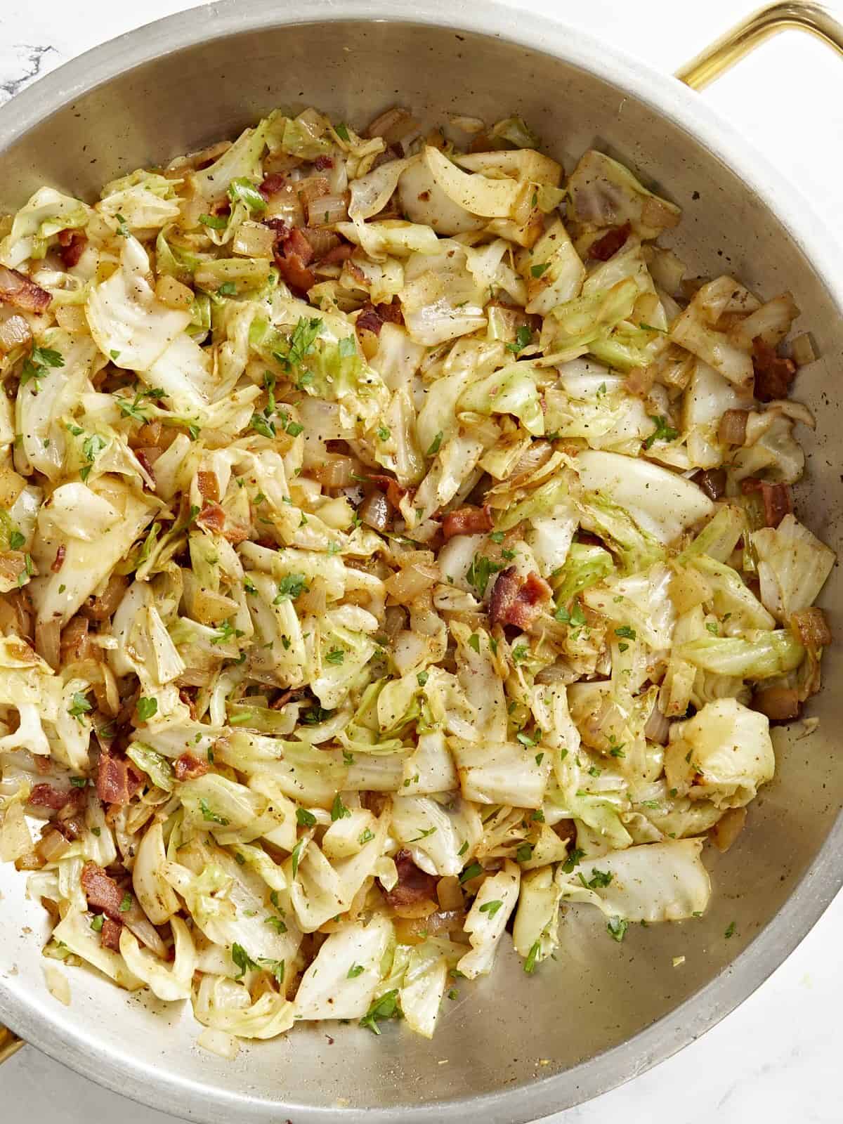 Overhead view of fried cabbage in a skillet.