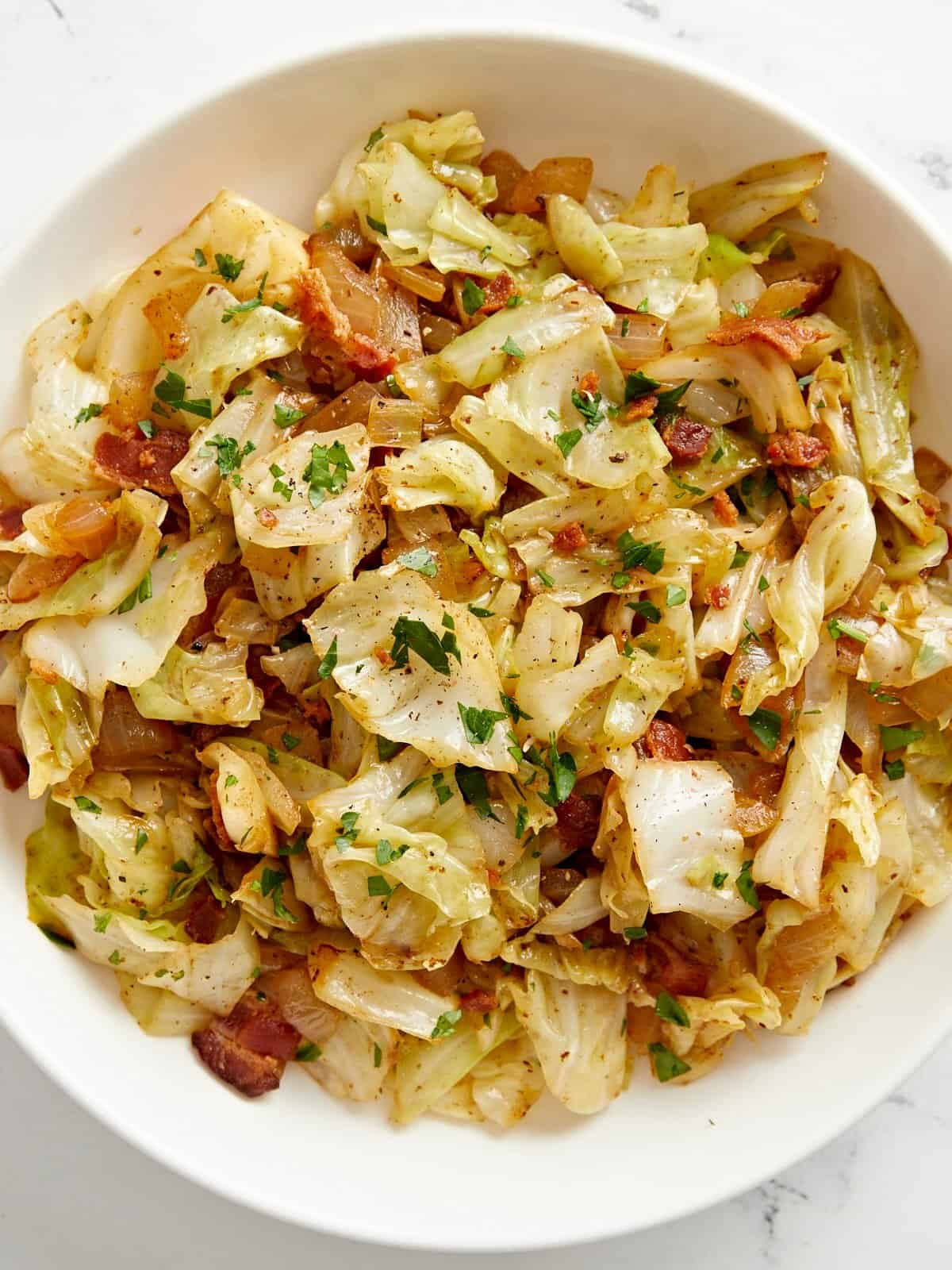 Close up overhead view of fried cabbage in a bowl.