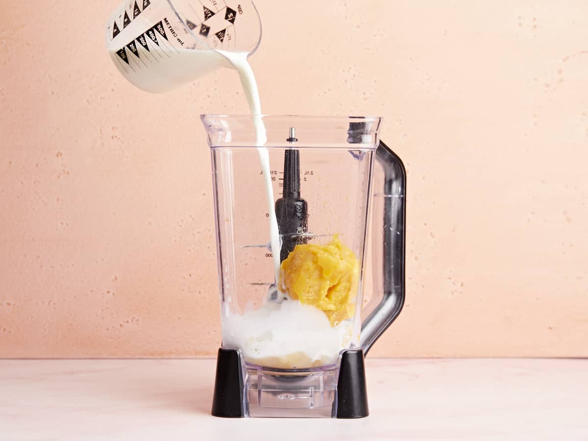 Ingredients being added to a blender.