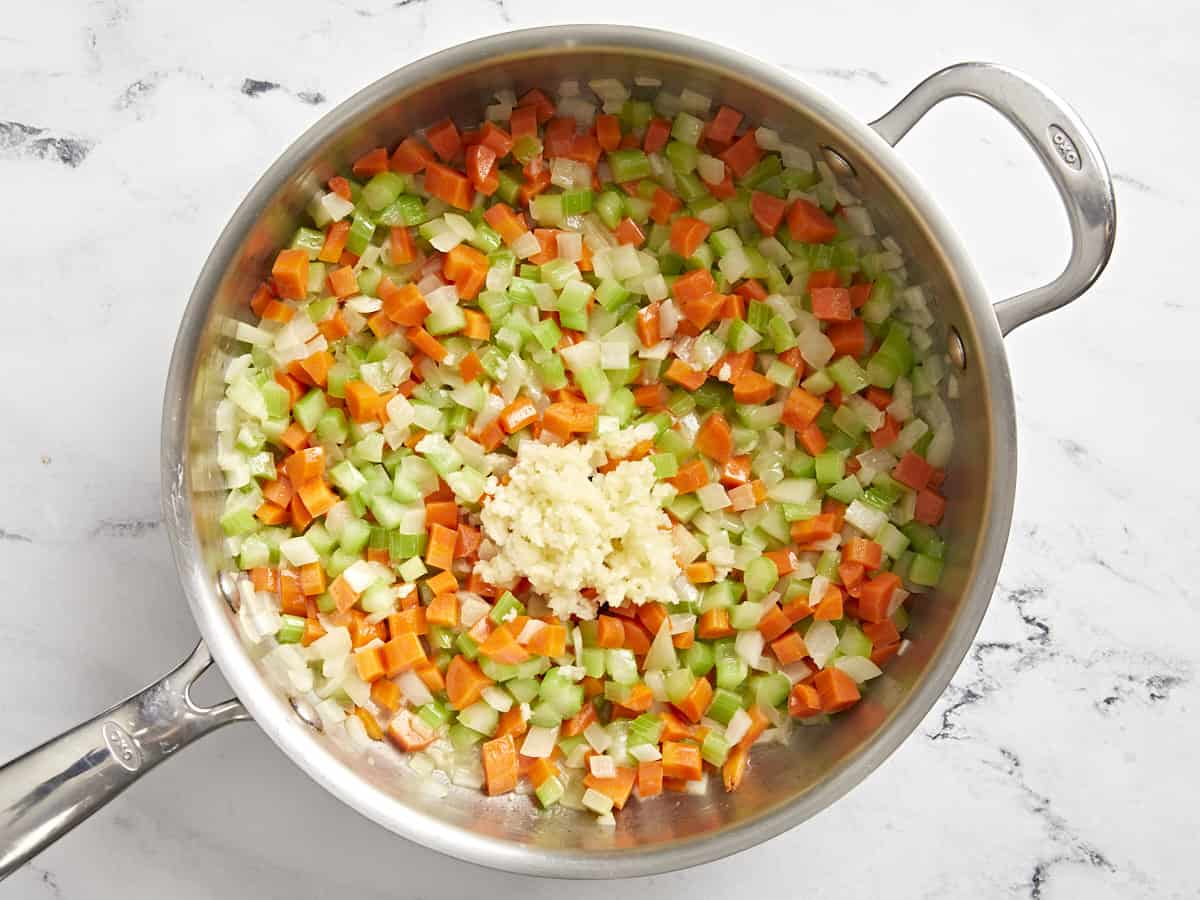 onion, carrot, celery, and garlic in a pan.